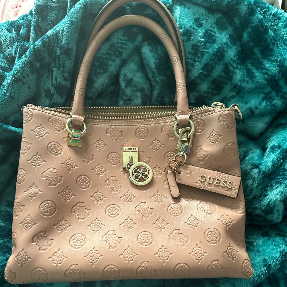 Pink Guess Purse. 3 pockets. 2 of them zipper closure. One is a button closure